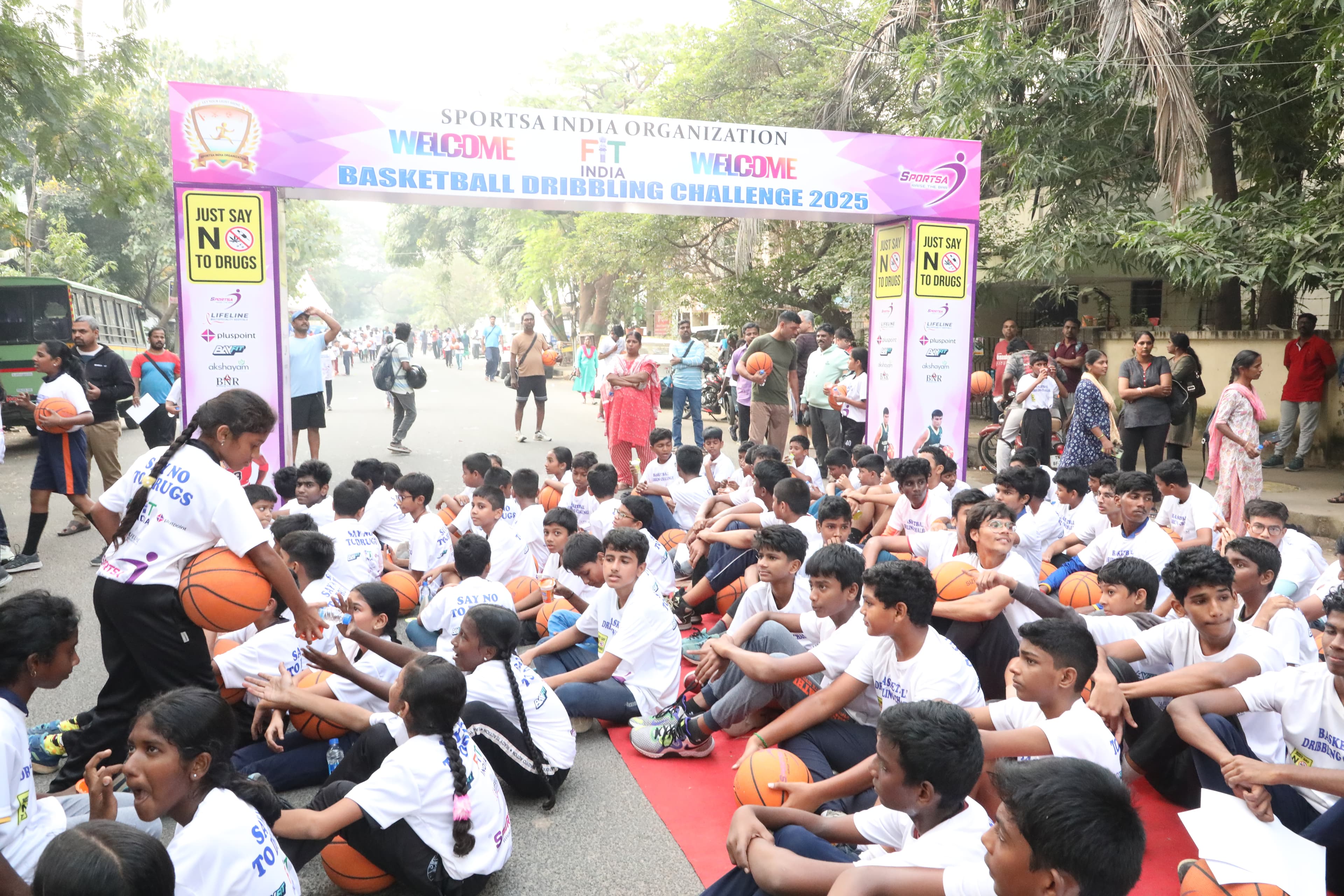 Sportsa trainer on the field with school students