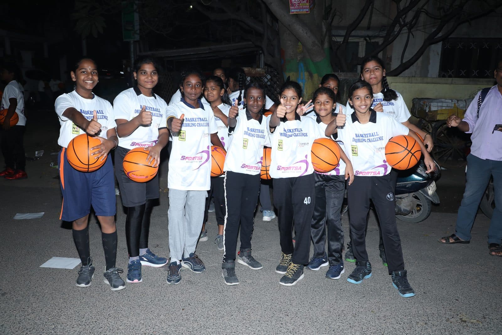 Students lined up with basketballs at the Sportsa Basketball Dribbling Challenge