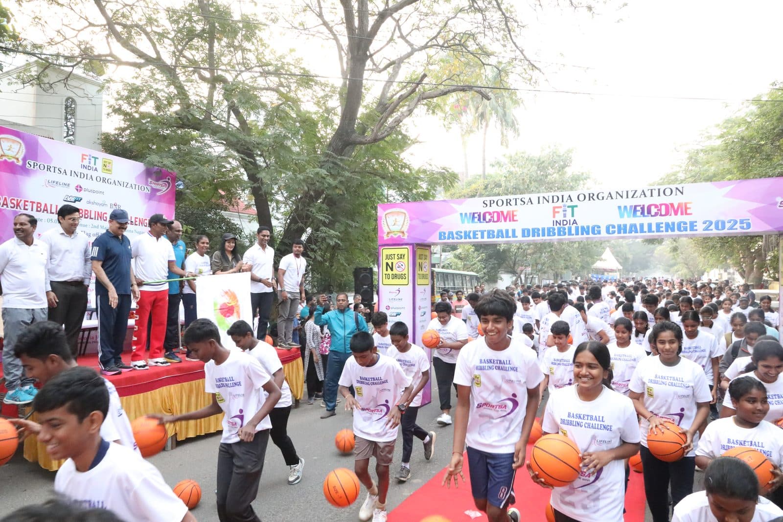 Young participants dribbling in formation at the Sportsa Basketball Dribbling Challenge