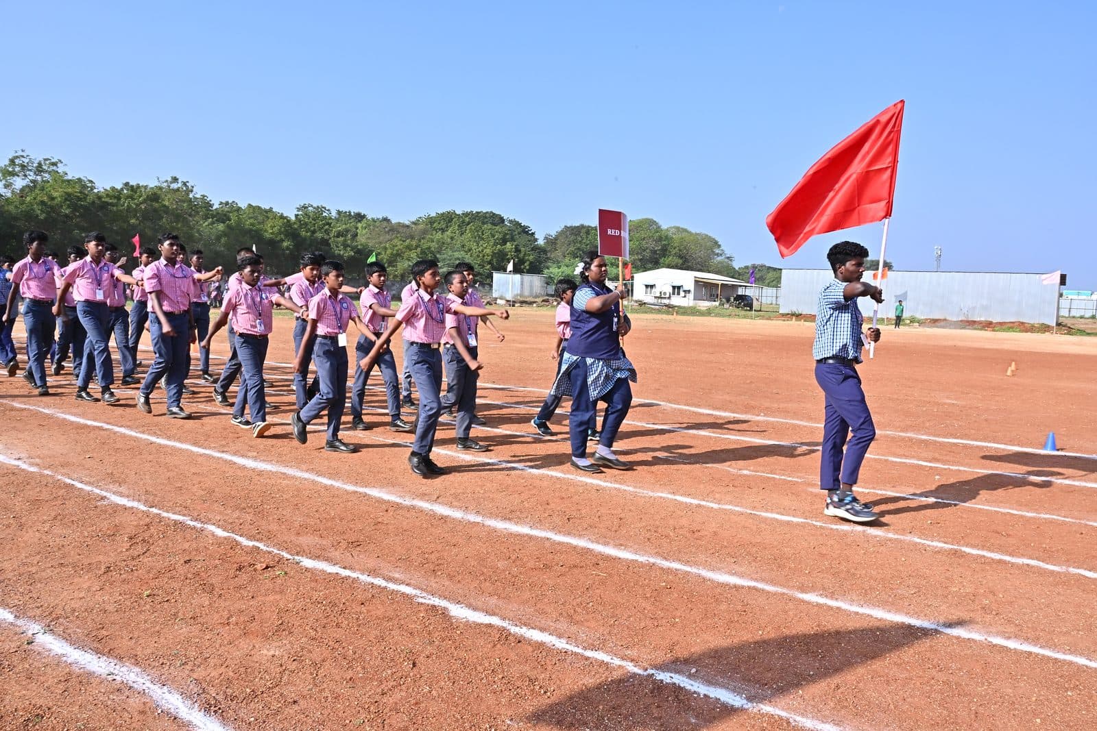 Students marching past during a school Sports Day organised by Sportsa