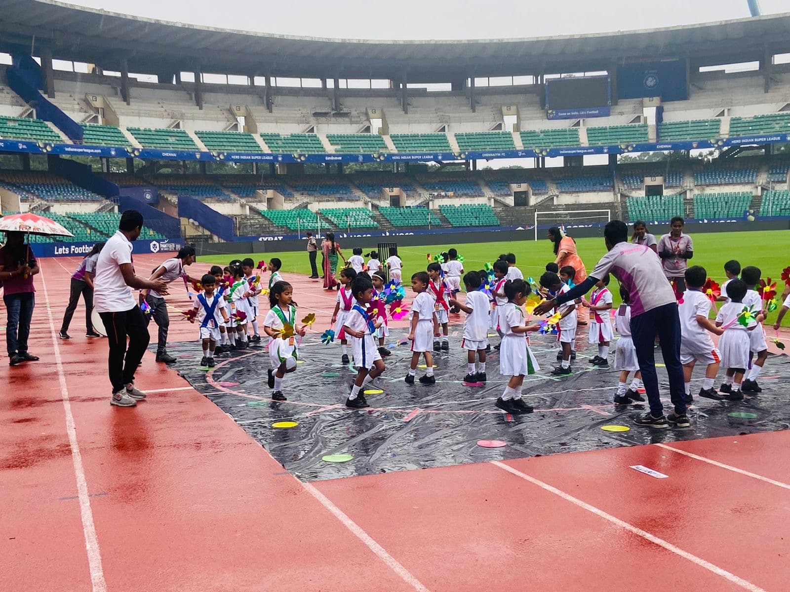 Sportsa trainers leading a physical education session with school students