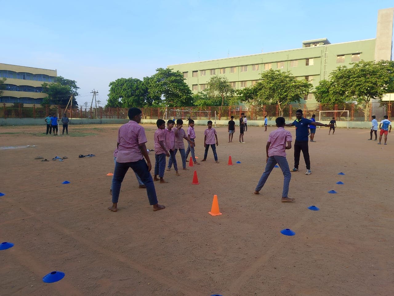 Students in an SIO drill formation with a coach on a Chennai school field